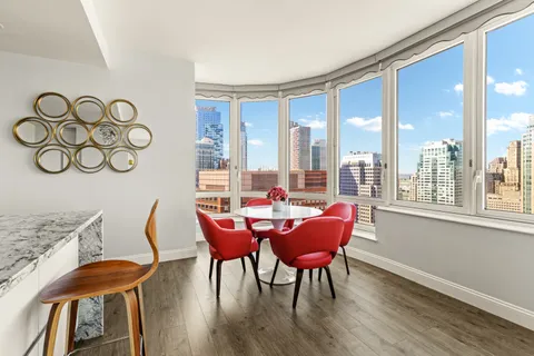 a dining room with furniture and wooden floor