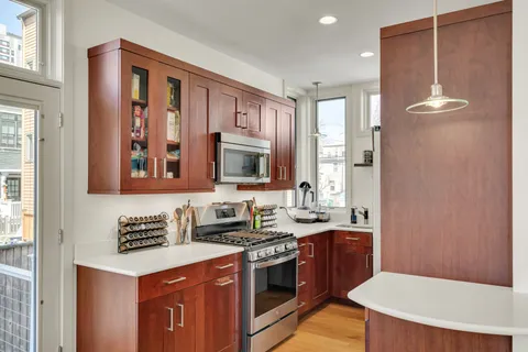 a kitchen with a sink stove and cabinets