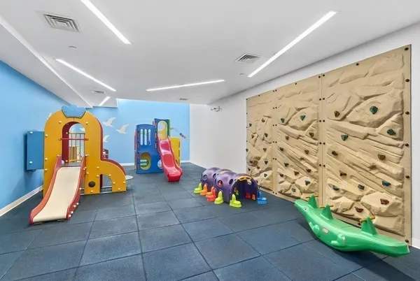 a room with lots of furniture and view of kitchen