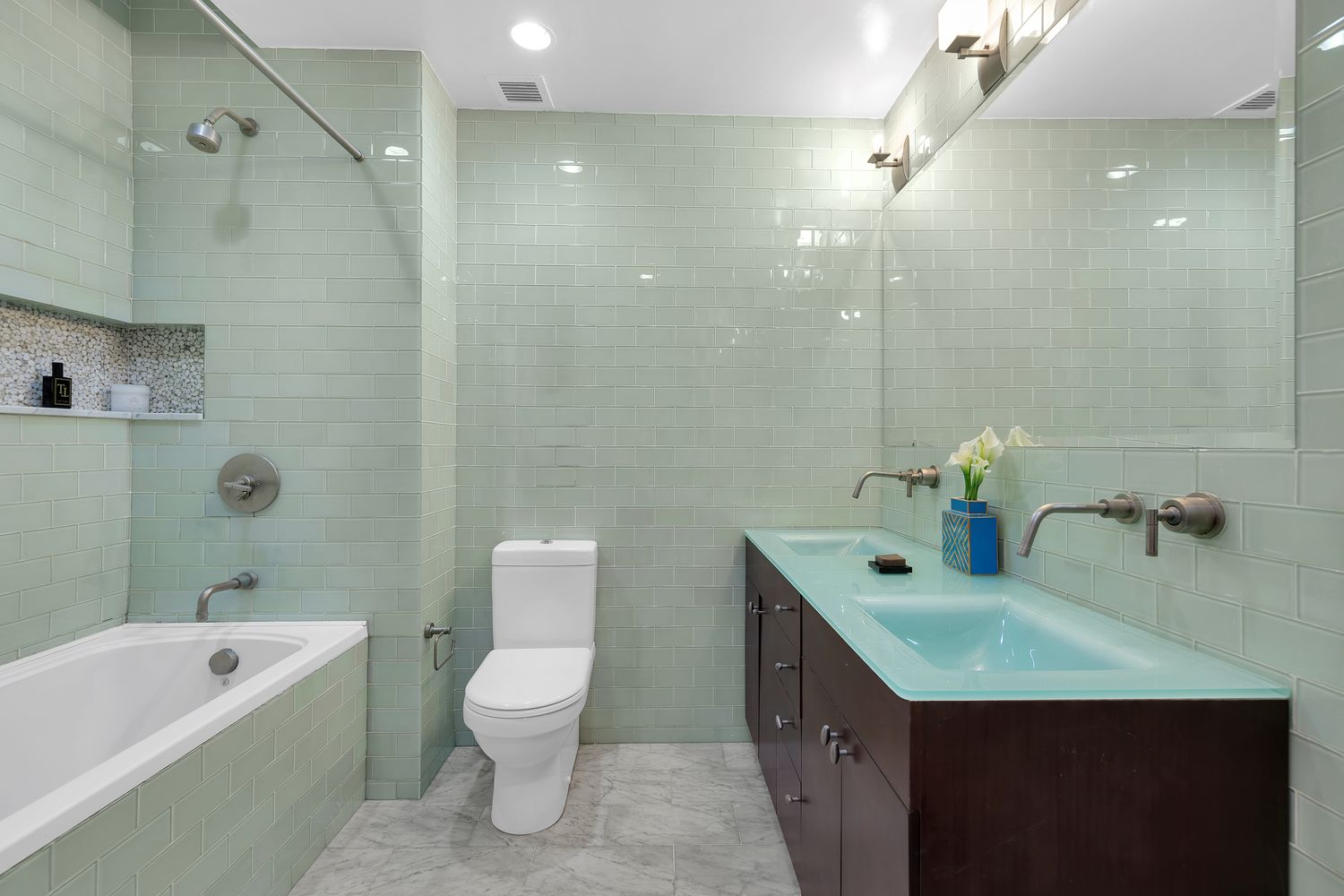 a bathroom with a granite countertop sink a toilet and shower