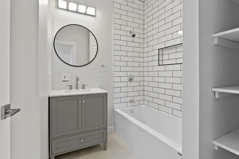 a bathroom with a sink a bathtub and a mirror