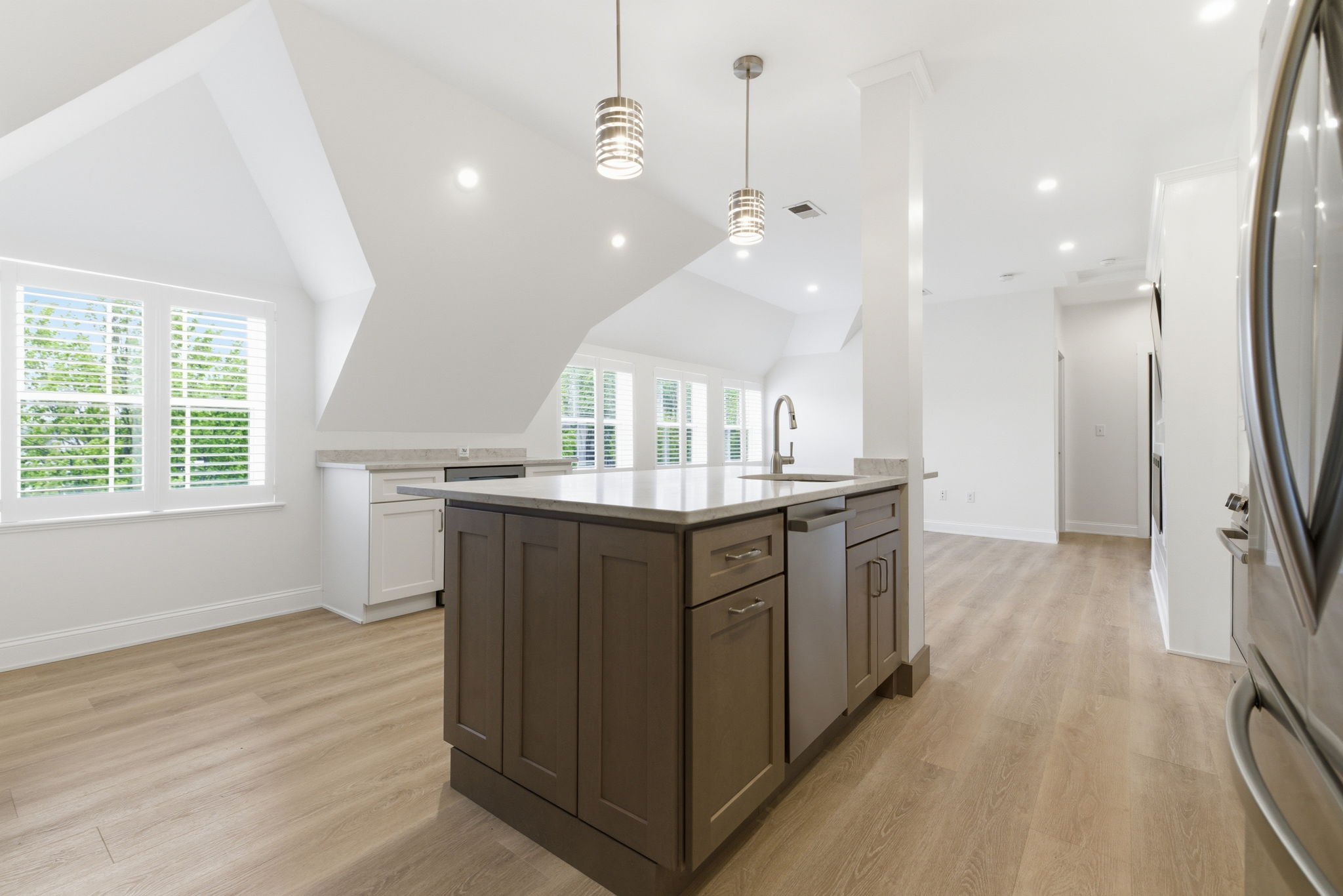 317 Main Street, Unit 7 Wakefield, MA 01880 - Photo 3 of 17 a kitchen with kitchen island granite countertop a sink counter top space and stainless steel appliances