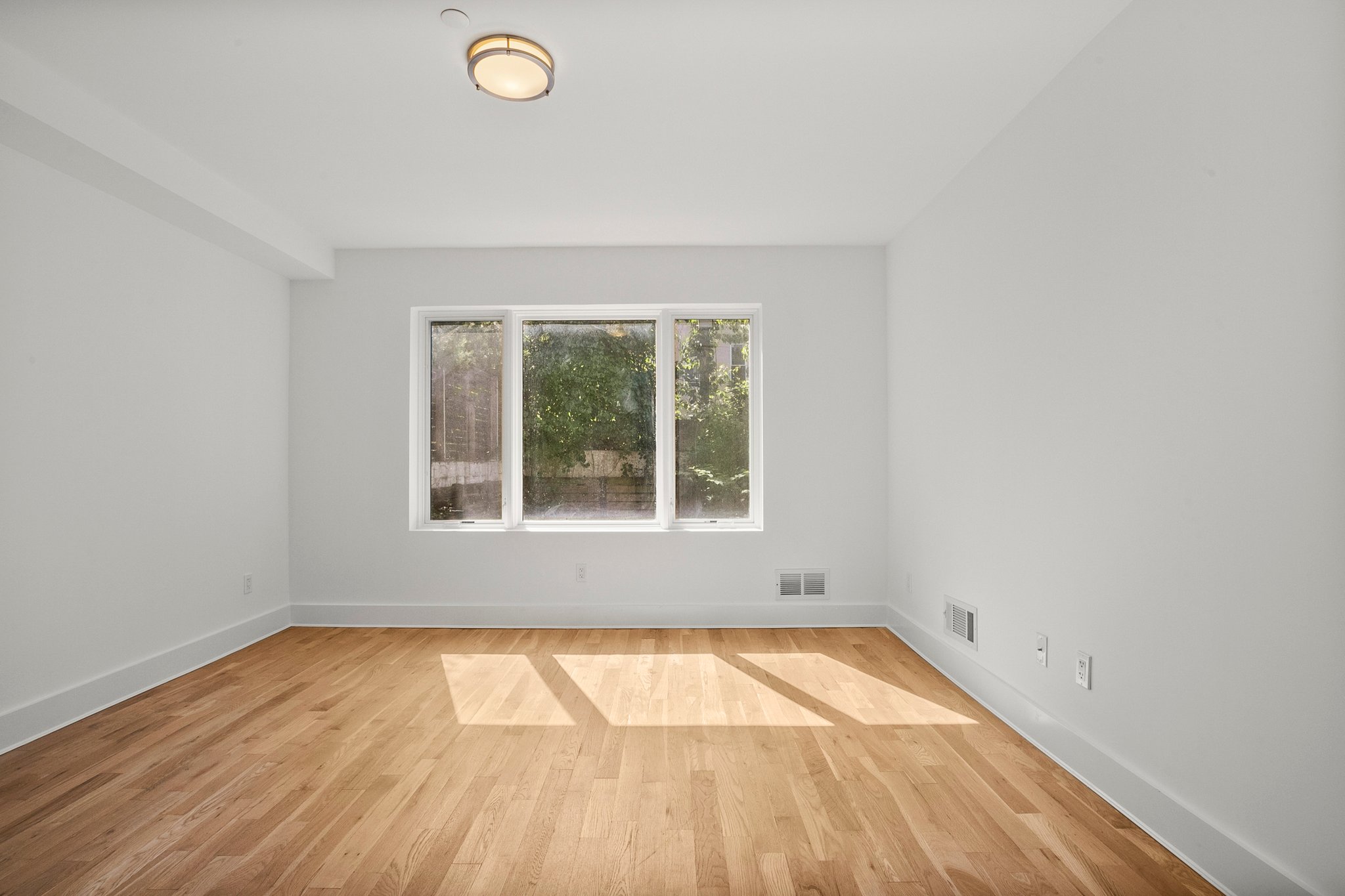 1130 Decatur Street Brooklyn, NY 11207 - Photo 17 of 24 an empty room with a window