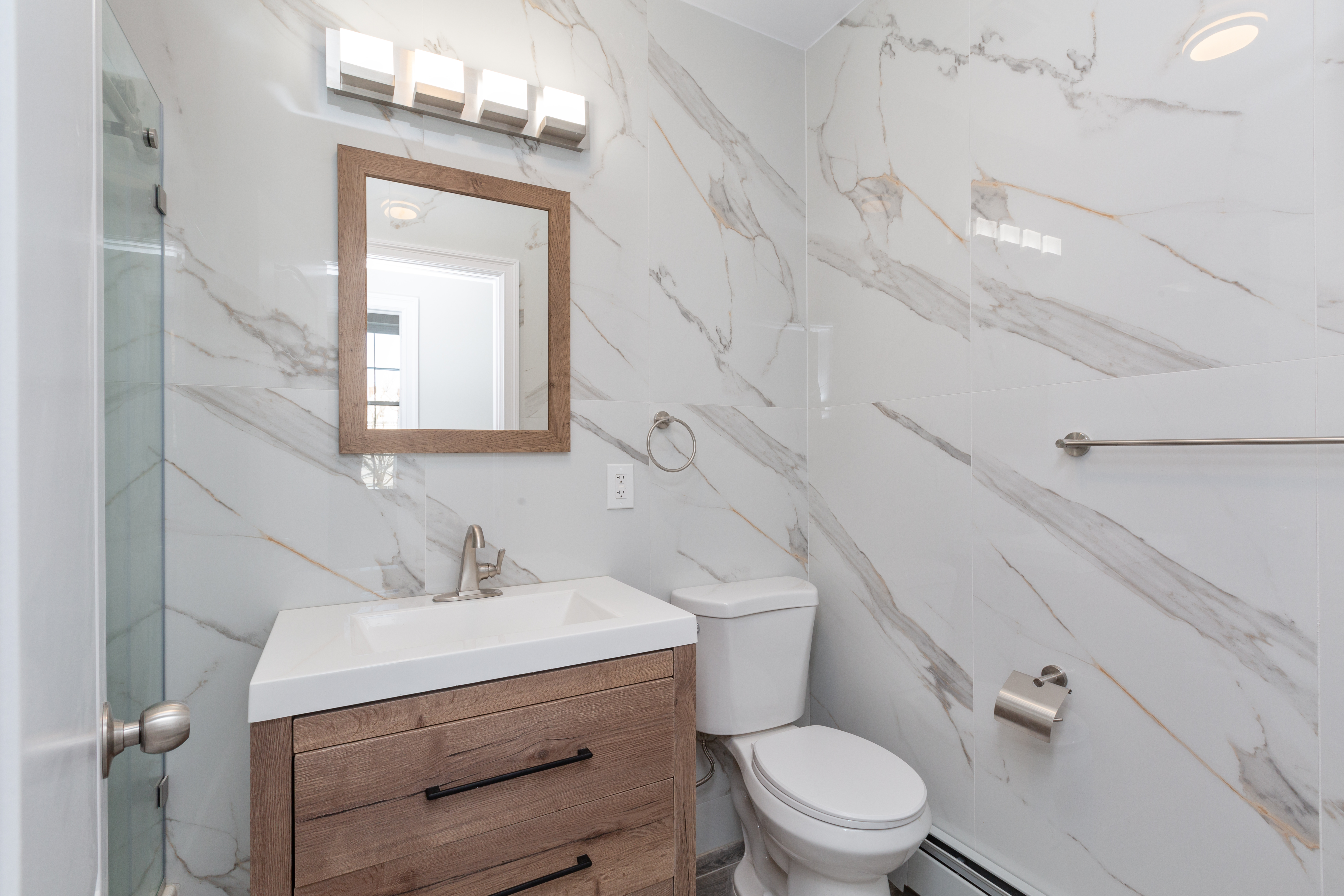 143-10 Shore Avenue Queens, NY 11435 - Photo 11 of 30 a bathroom with a toilet a sink and mirror