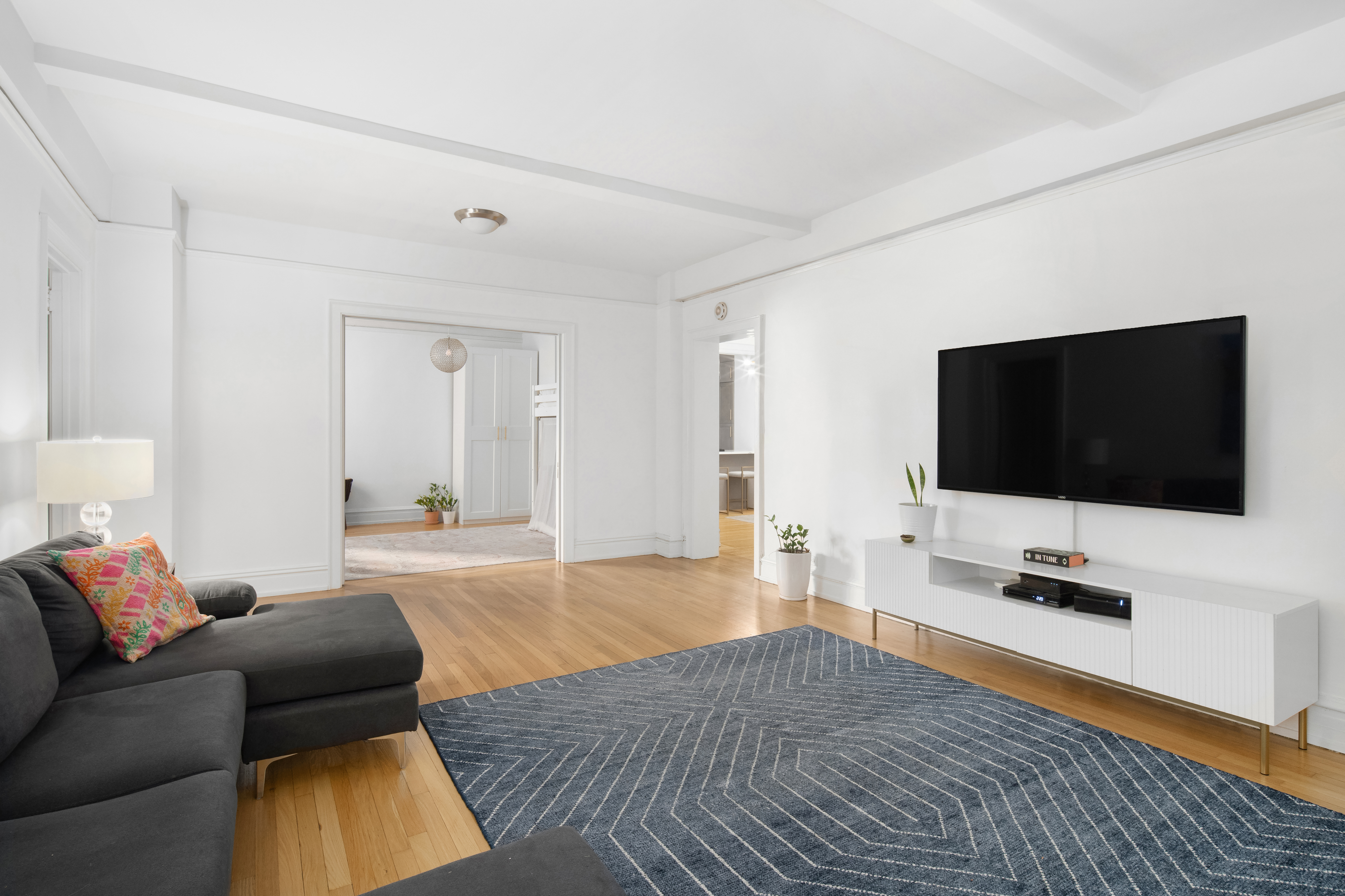 150 West 55th Street, Unit 5D Manhattan, NY 10019 - Photo 6 of 12 a living room with furniture and a flat screen tv