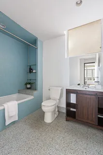a bathroom with a sink a toilet and bathtub