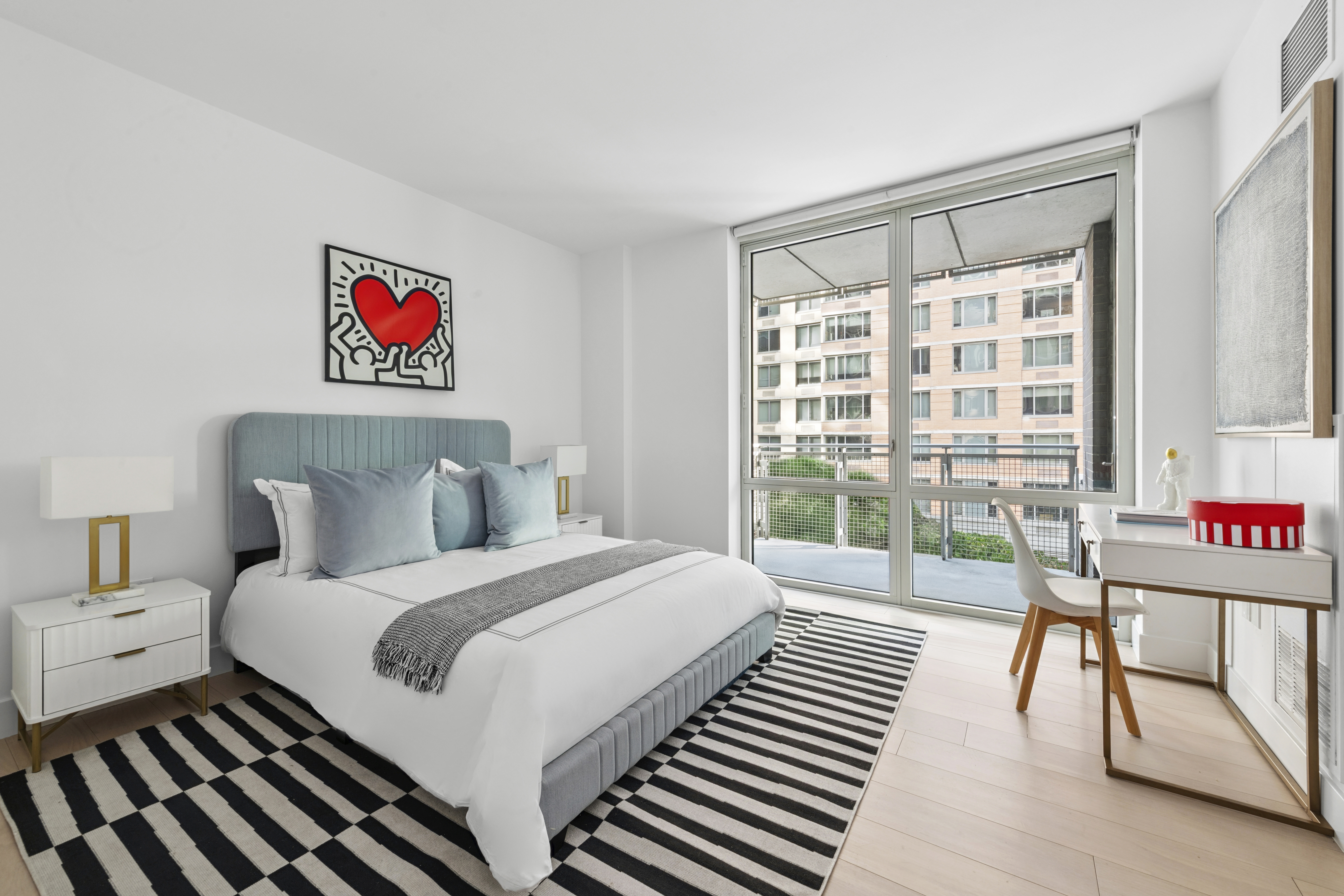 225 East 34th Street, Unit 5E Manhattan, NY 10016 - Photo 9 of 23 a bedroom with a bed and a table