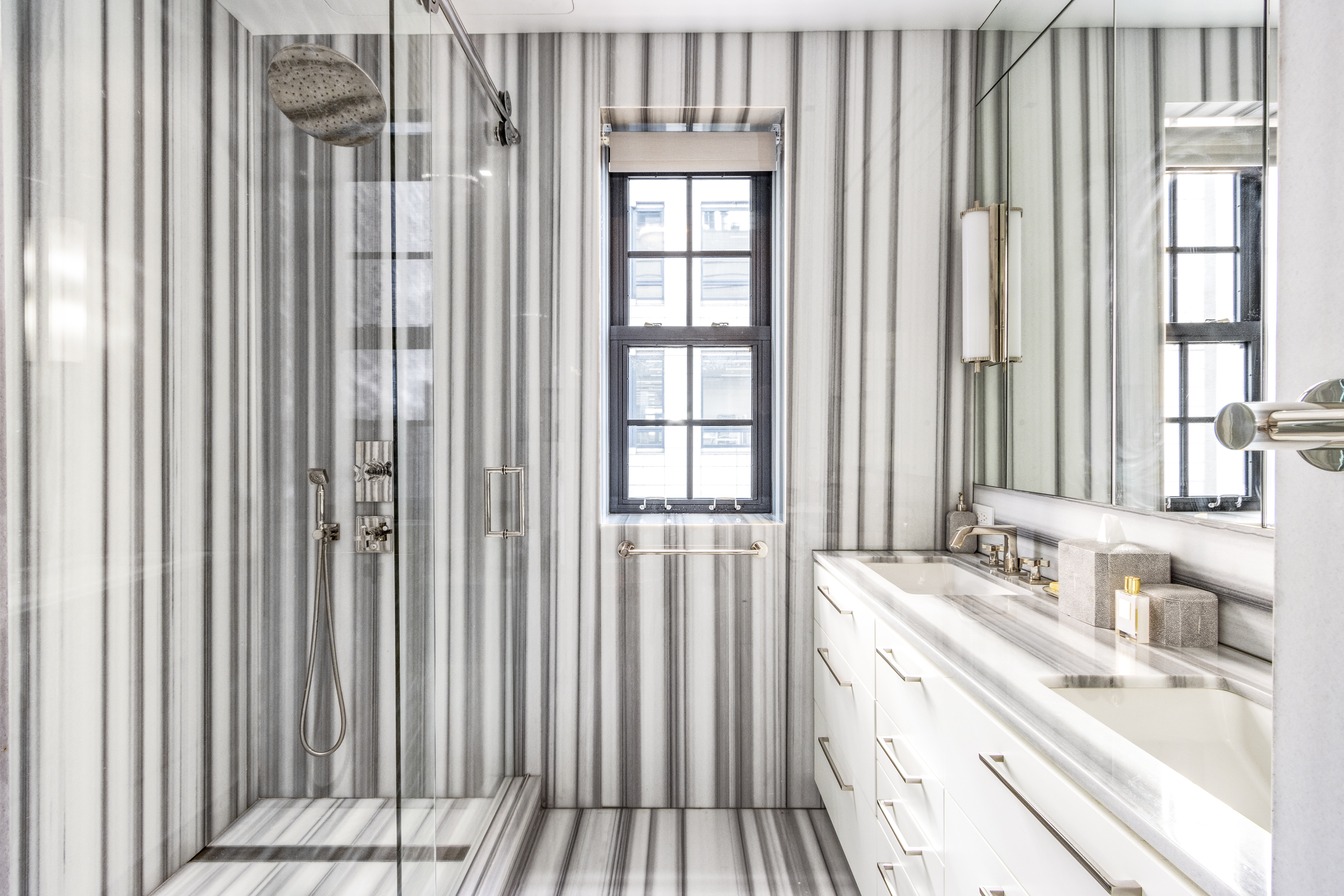 40 East 61st Street, Unit 18A Manhattan, NY 10065 - Photo 8 of 15 a bathroom with a granite countertop sink and a large mirror