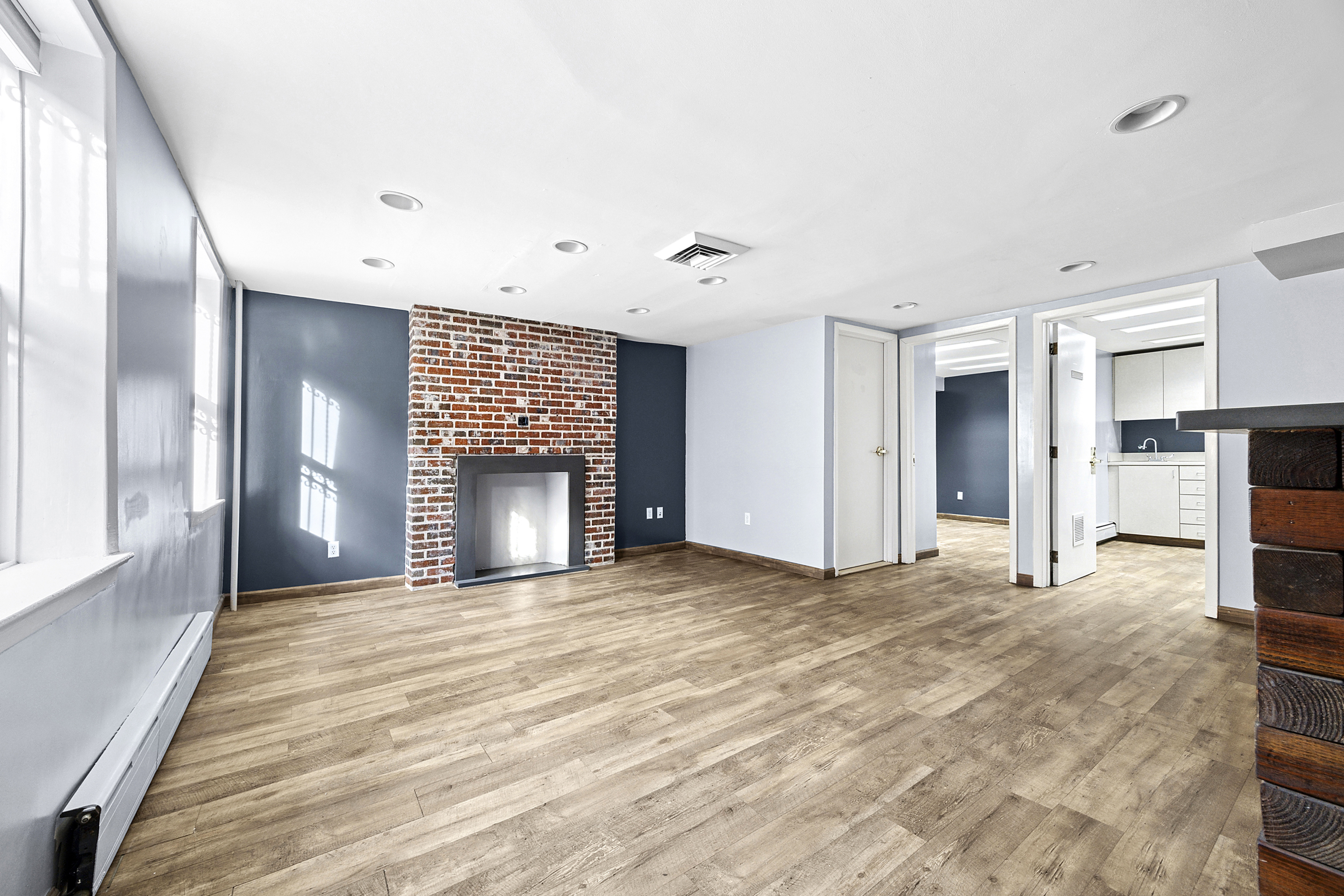 153 Clinton Street, Ofc Brooklyn, NY 11201 - Photo 1 of 13 a view of an empty room with a fireplace and a window