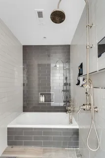 a bathroom with a bathtub and a shower