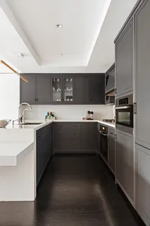 a kitchen with stainless steel appliances kitchen island granite countertop a sink refrigerator and cabinets