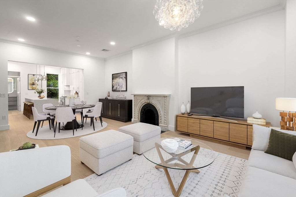 34 Worcester Square, Unit 2 Boston, MA 02118 - Photo 3 of 18 a living room with furniture a flat screen tv and a fireplace