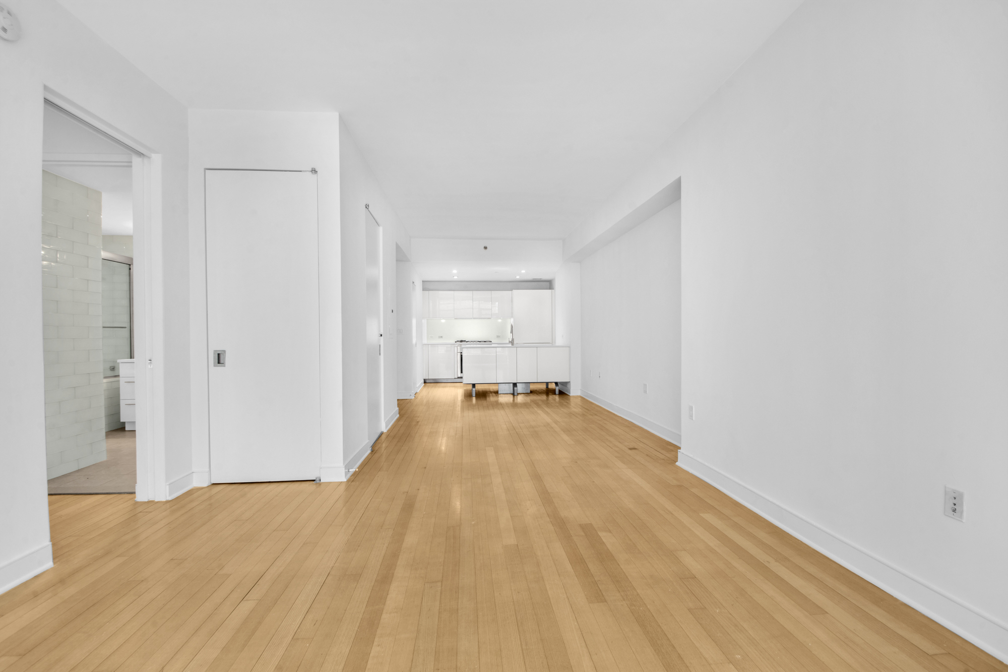 5 East 44th Street, Unit 5A Manhattan, NY 10017 - Photo 10 of 15 a view of a room with wooden floor and closet