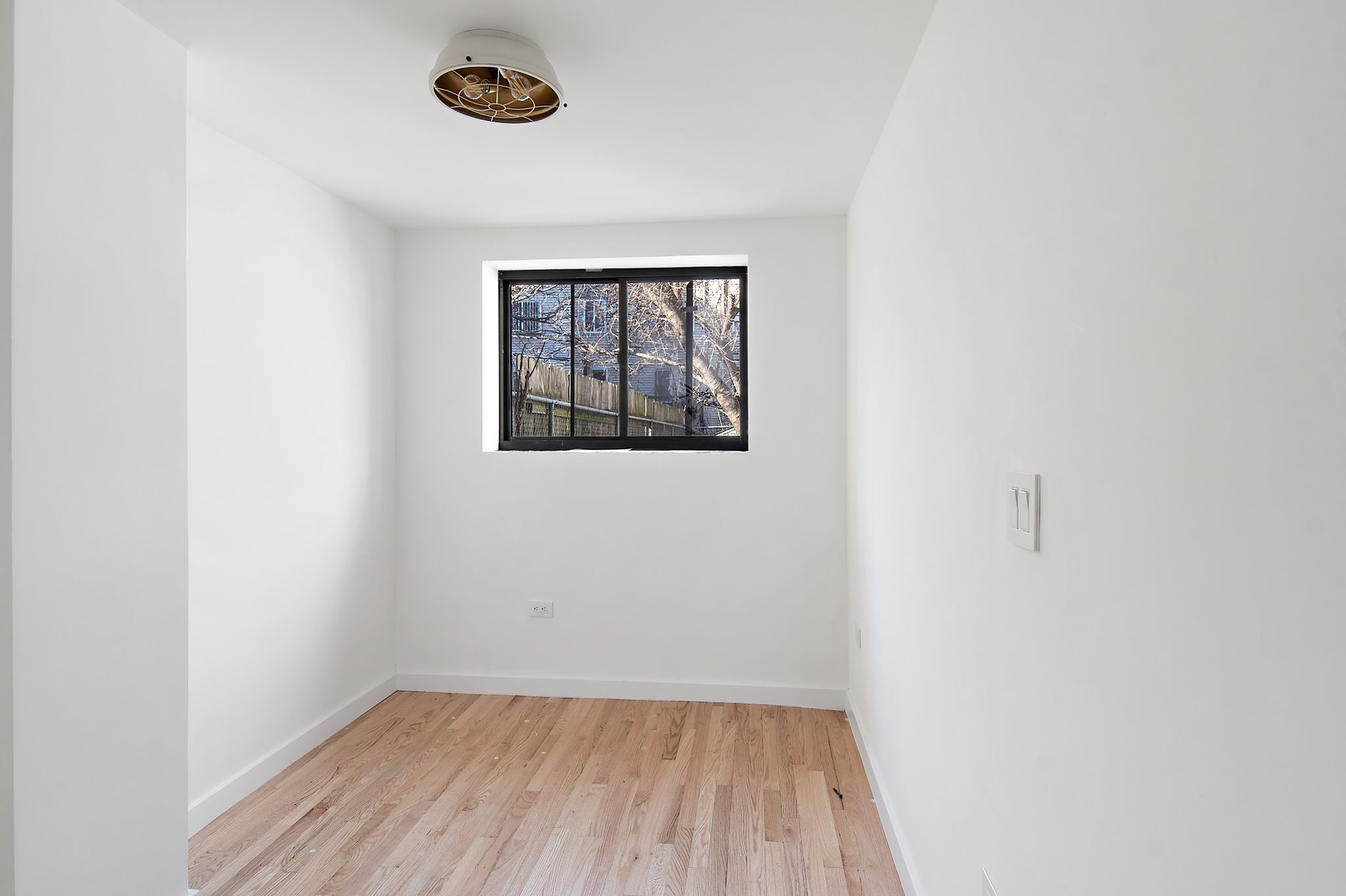 181 Kosciuszko Street Brooklyn, NY 11216 - Photo 18 of 20 a view of a small space with wooden floor and a window
