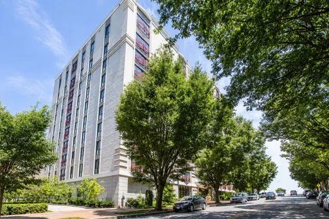 a view of a tall building next to a road