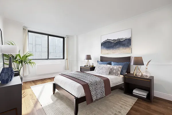 280 Park Avenue South, Unit 4F Manhattan, NY 10010 - Photo 2 of 7 a bedroom with a bed lamp and a potted plant