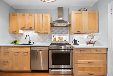 a kitchen with granite countertop a stove and a sink