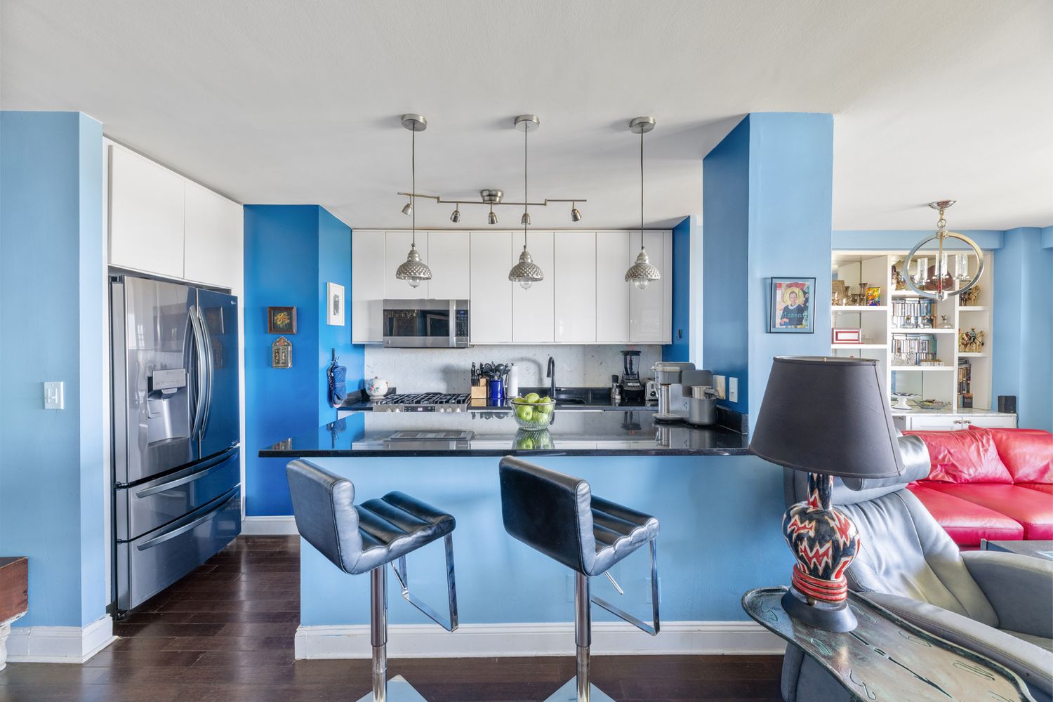 a kitchen with stainless steel appliances granite countertop a refrigerator and microwave