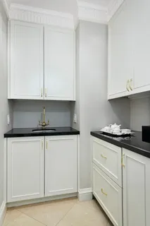 a kitchen with granite countertop white cabinets and a stove