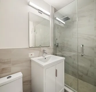 a bathroom with a sink a toilet and a mirror