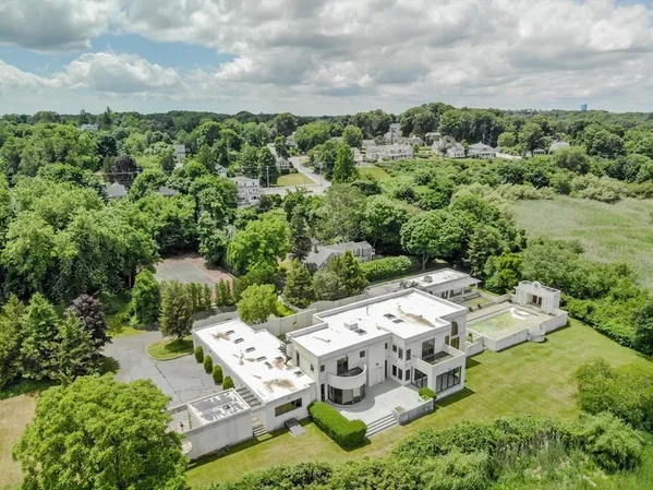 an aerial view of a house with a yard basket ball court and outdoor seating