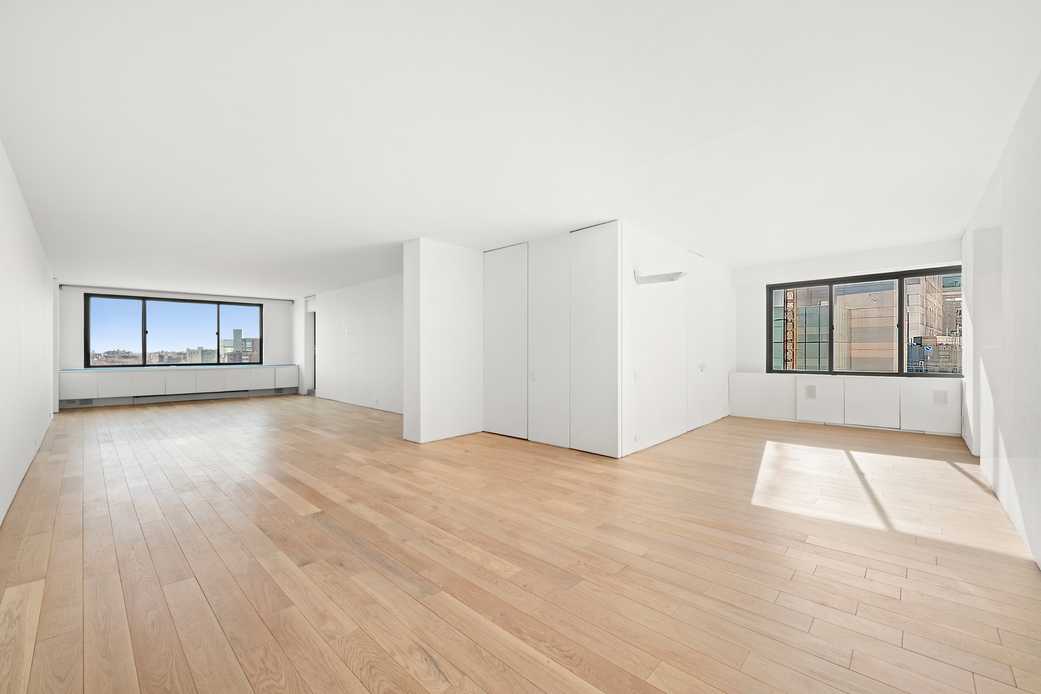 530 East 72nd Street, Unit 14E Manhattan, NY 10021 - Photo 2 of 19 a view of an empty room with window and wooden floor