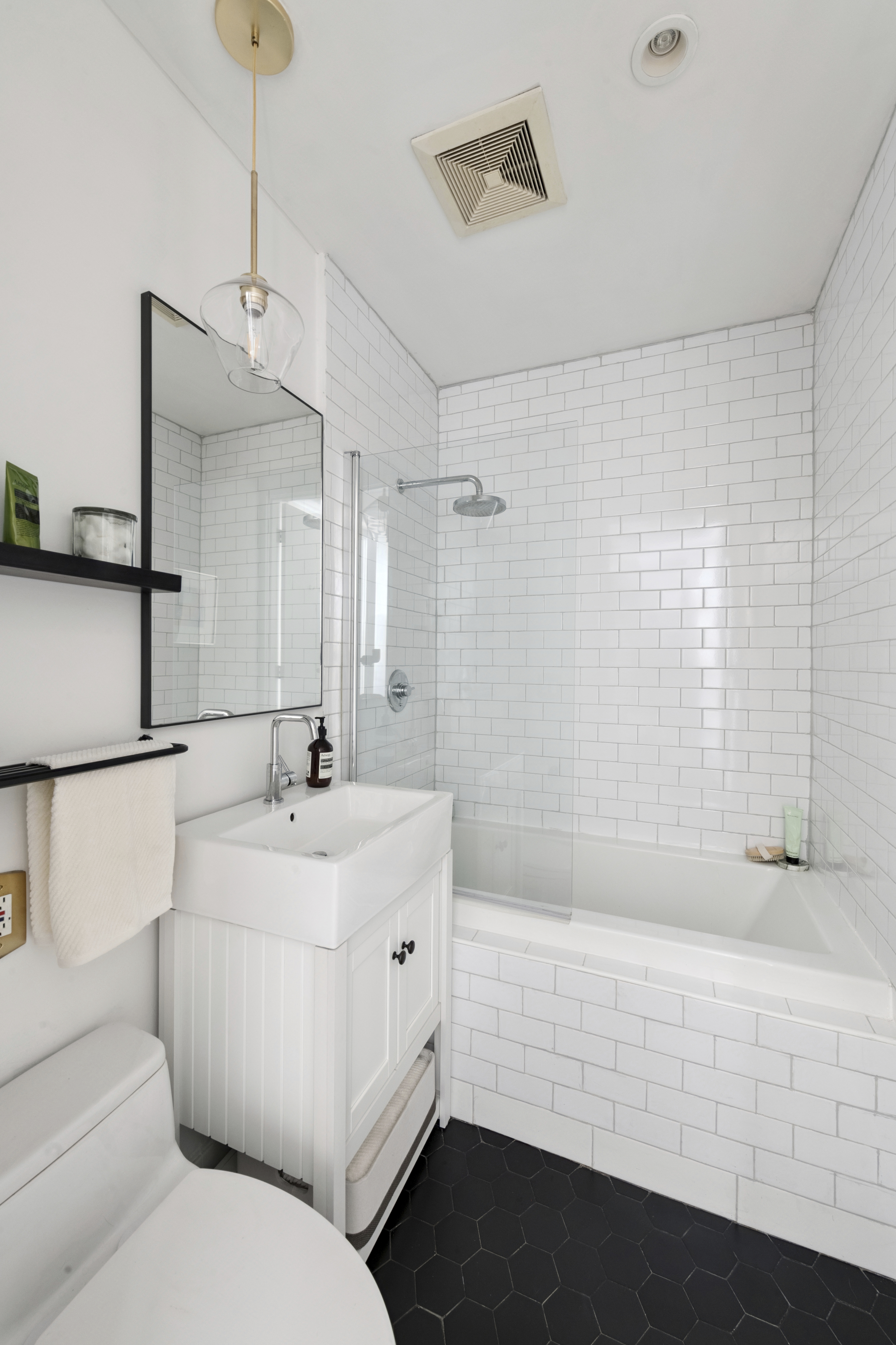 82 Adelphi Street, Unit 3D Brooklyn, NY 11205 - Photo 6 of 7 a bathroom with a sink a toilet and shower