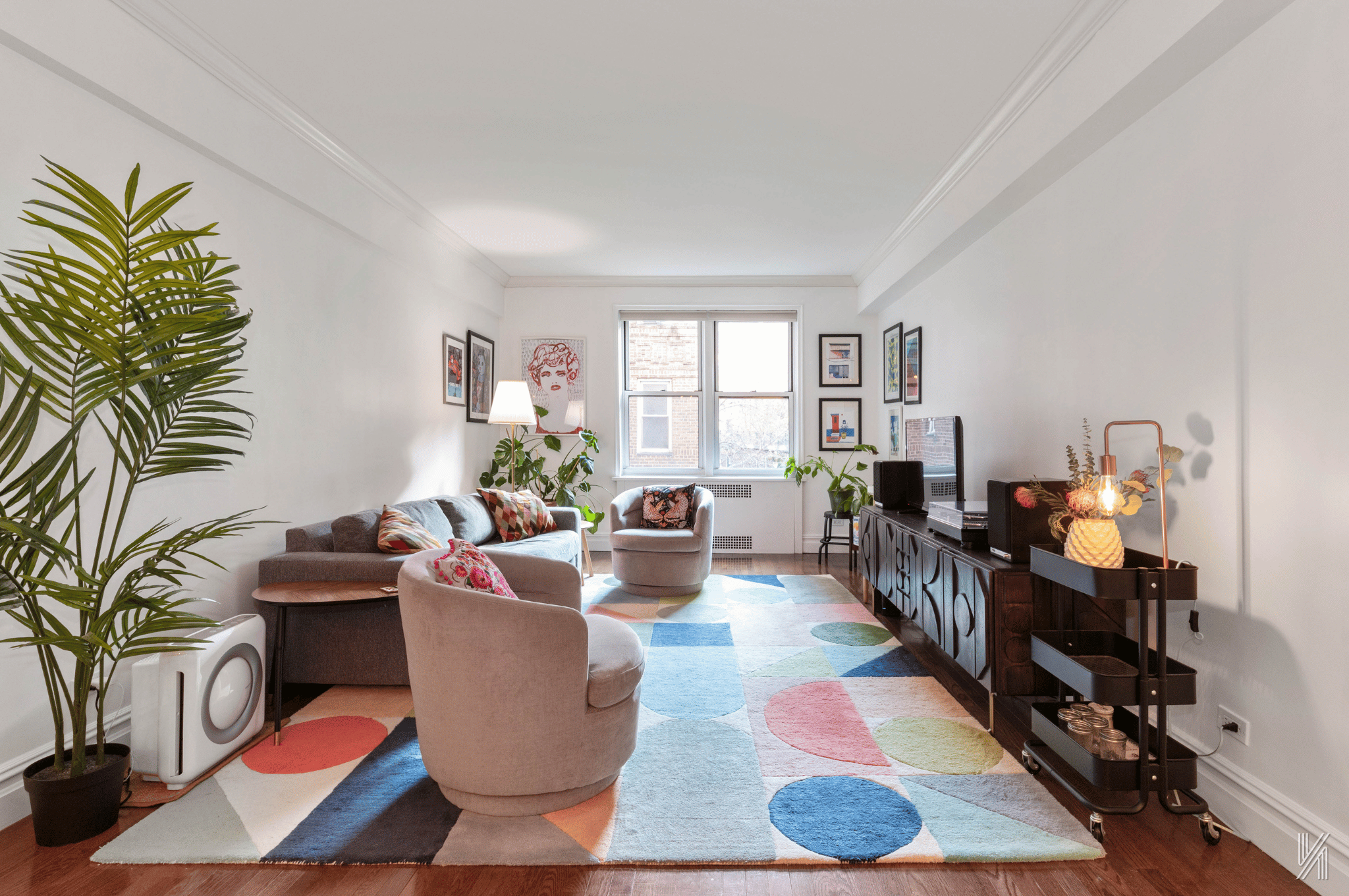 73-12 35th Avenue, Unit E23 Queens, NY 11372 - Photo 3 of 16 a living room with furniture floor to ceiling window and potted plant