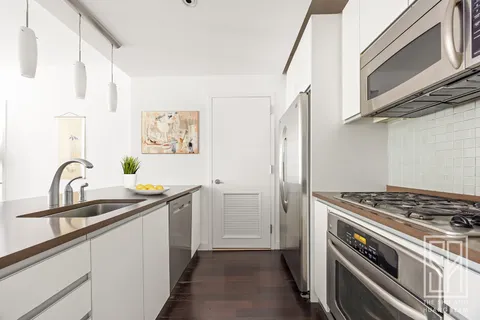 a kitchen with stainless steel appliances a sink a stove and a refrigerator