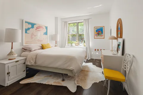 a bedroom with a bed and a couch