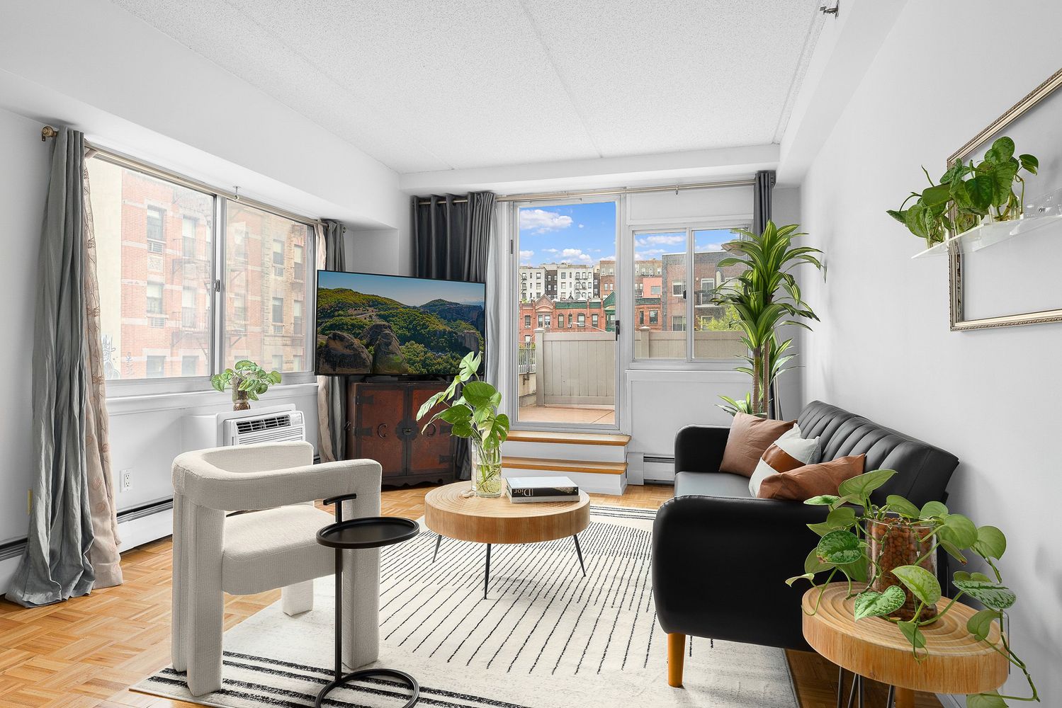 300 West 145th Street, Unit 1QQ Manhattan, NY 10039 - Photo 4 of 15 a living room with furniture and a floor to ceiling window