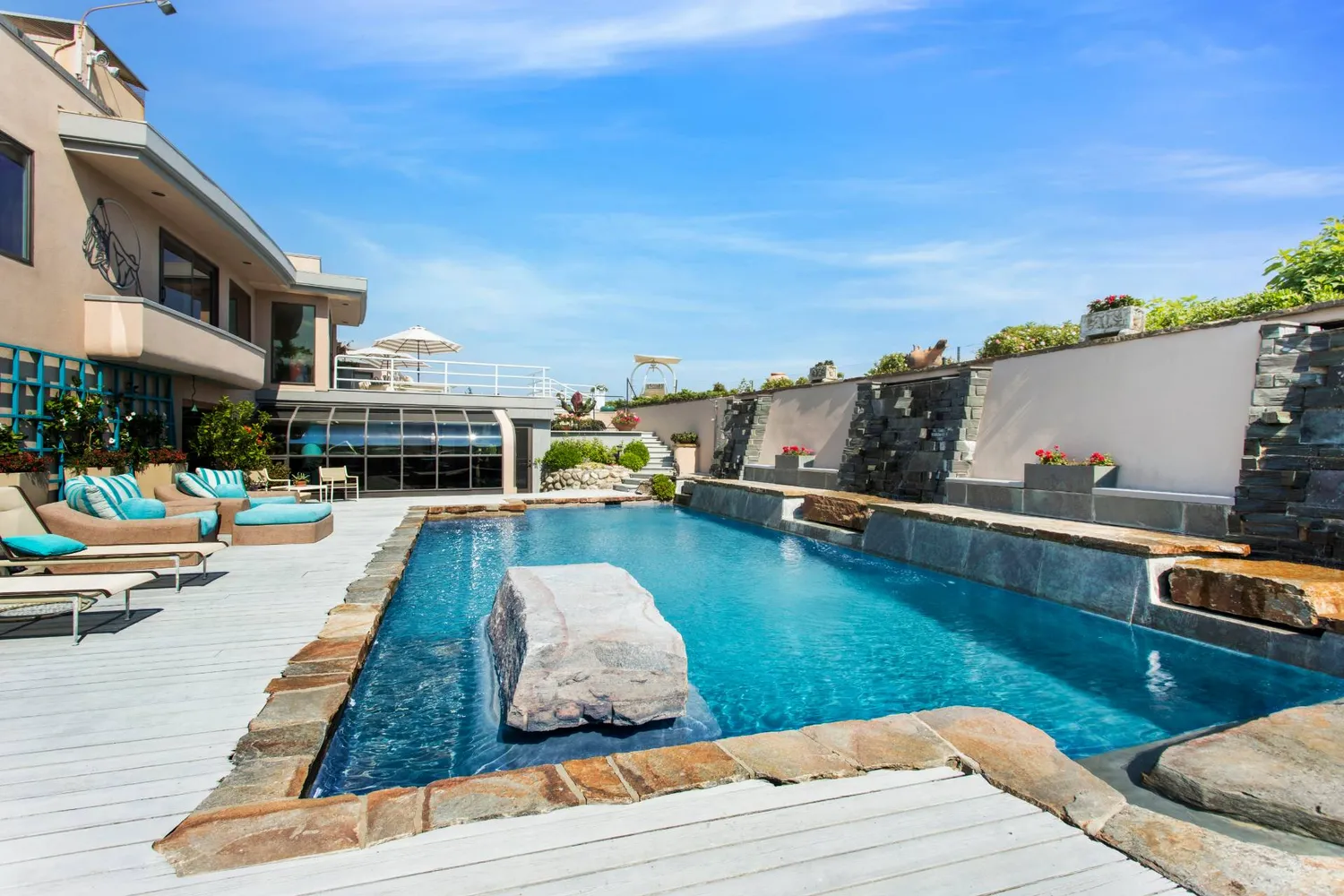 a swimming pool with outdoor seating and yard