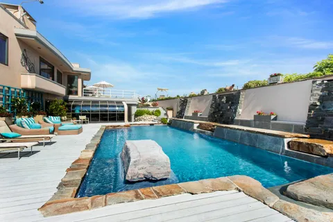 a swimming pool with outdoor seating and yard