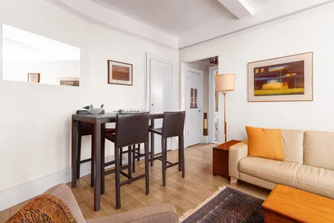 a view of a livingroom and a dining room with furniture