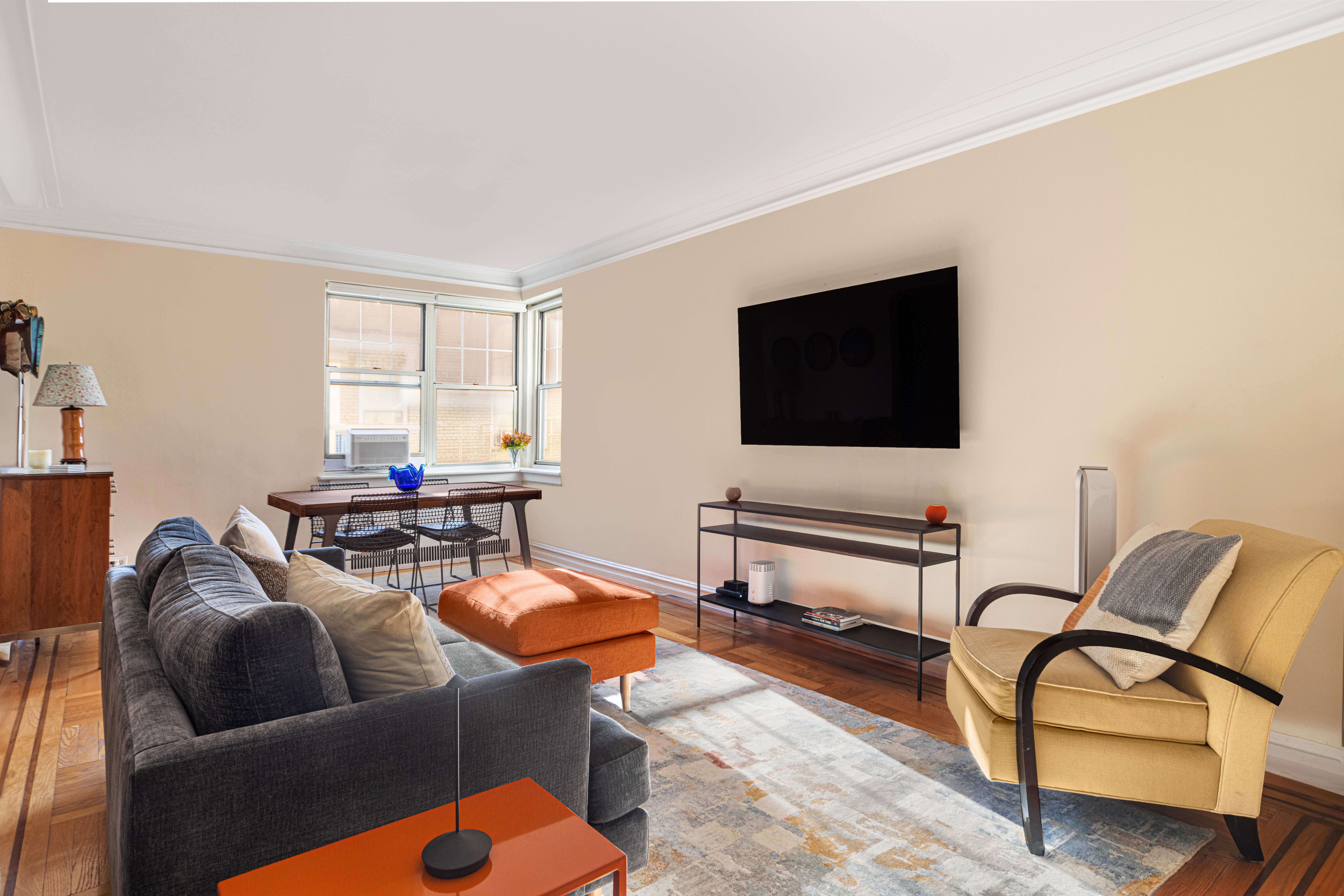 720 Fort Washington Avenue, Unit 6M Manhattan, NY 10040 - Photo 3 of 18 a living room with furniture and a flat screen tv