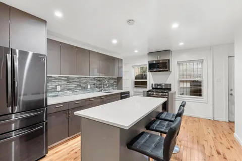 a kitchen with a refrigerator a stove a sink and a refrigerator