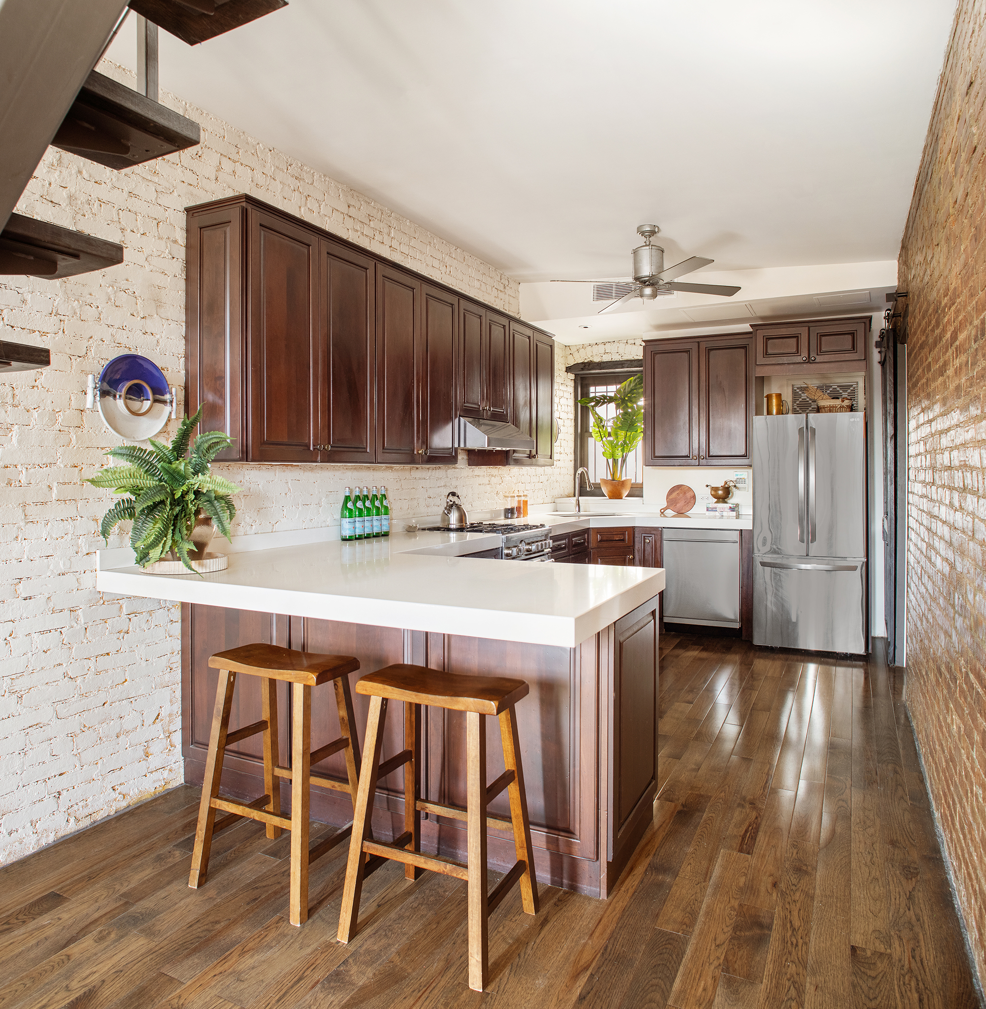 300 East 4th Street, Unit 5CD Manhattan, NY 10009 - Photo 6 of 11 a kitchen with stainless steel appliances granite countertop a stove a refrigerator a sink and a microwave