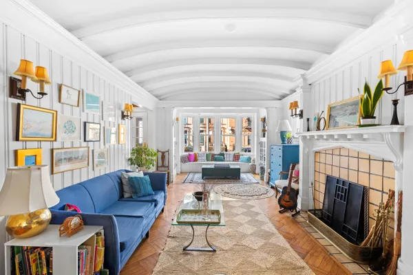 a living room with furniture and a fireplace