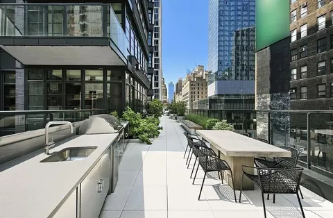 a view of a patio with table and chairs and potted plants
