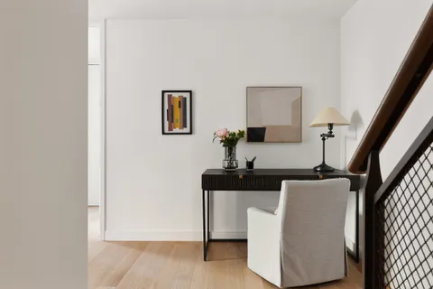 a living room with furniture and a potted plant