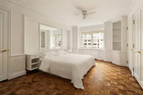 a spacious bedroom with a bed and a cabinets