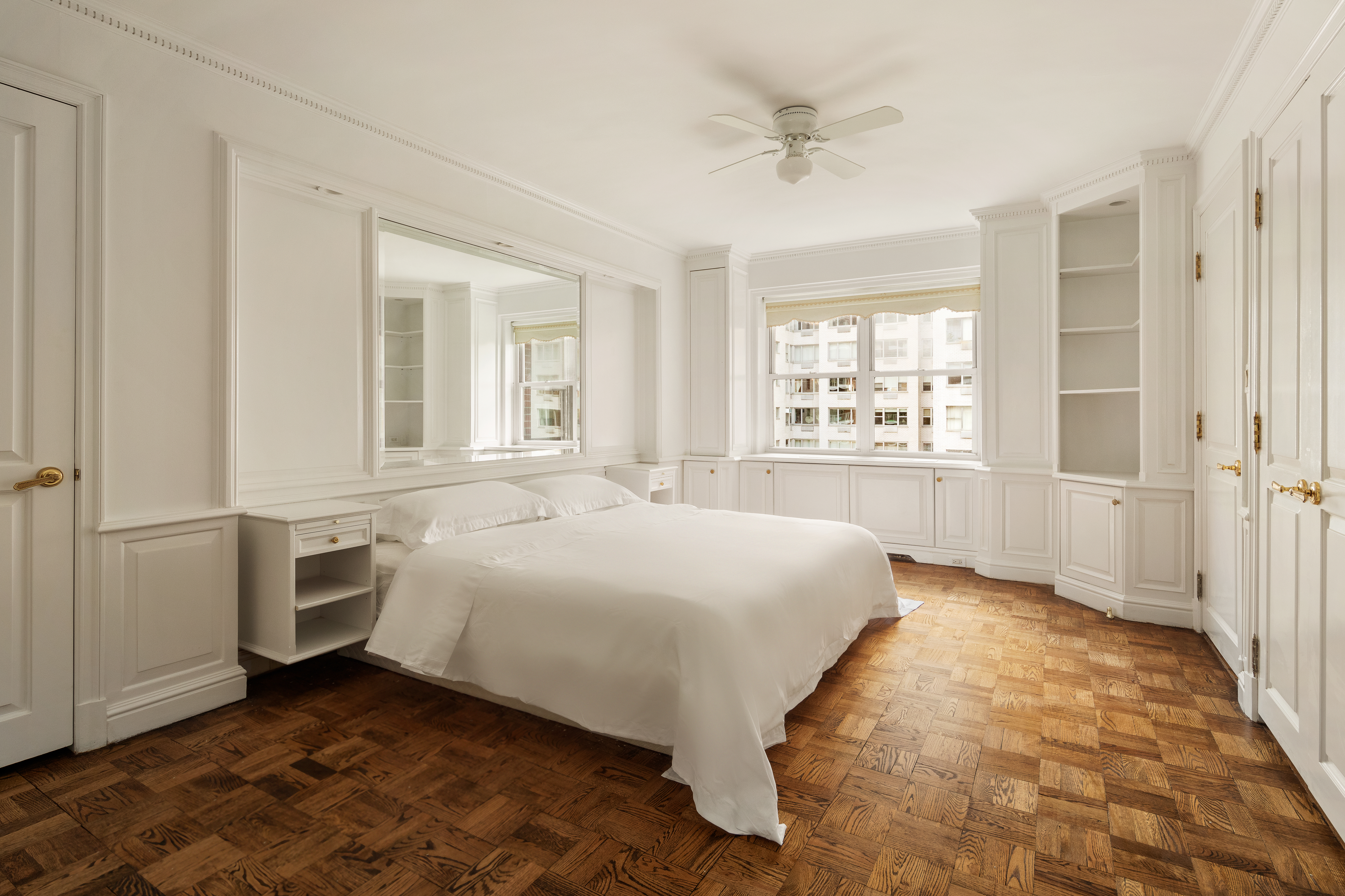 50 Sutton Place South, Unit 11H Manhattan, NY 10022 - Photo 7 of 10 a spacious bedroom with a bed and a cabinets
