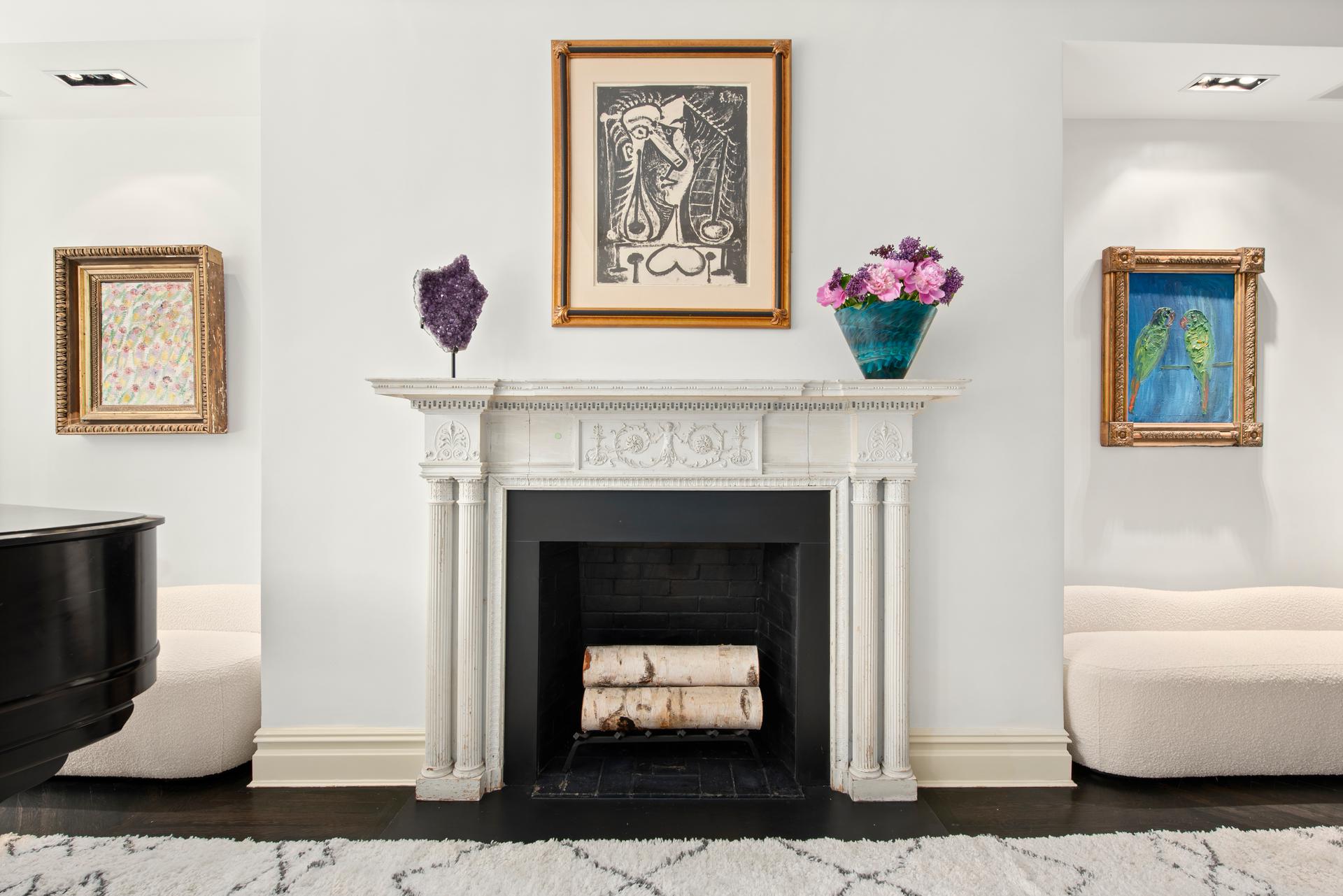 1140 5th Avenue, Unit 8C Manhattan, NY 10128 - Photo 4 of 16 a living room with furniture and a fireplace