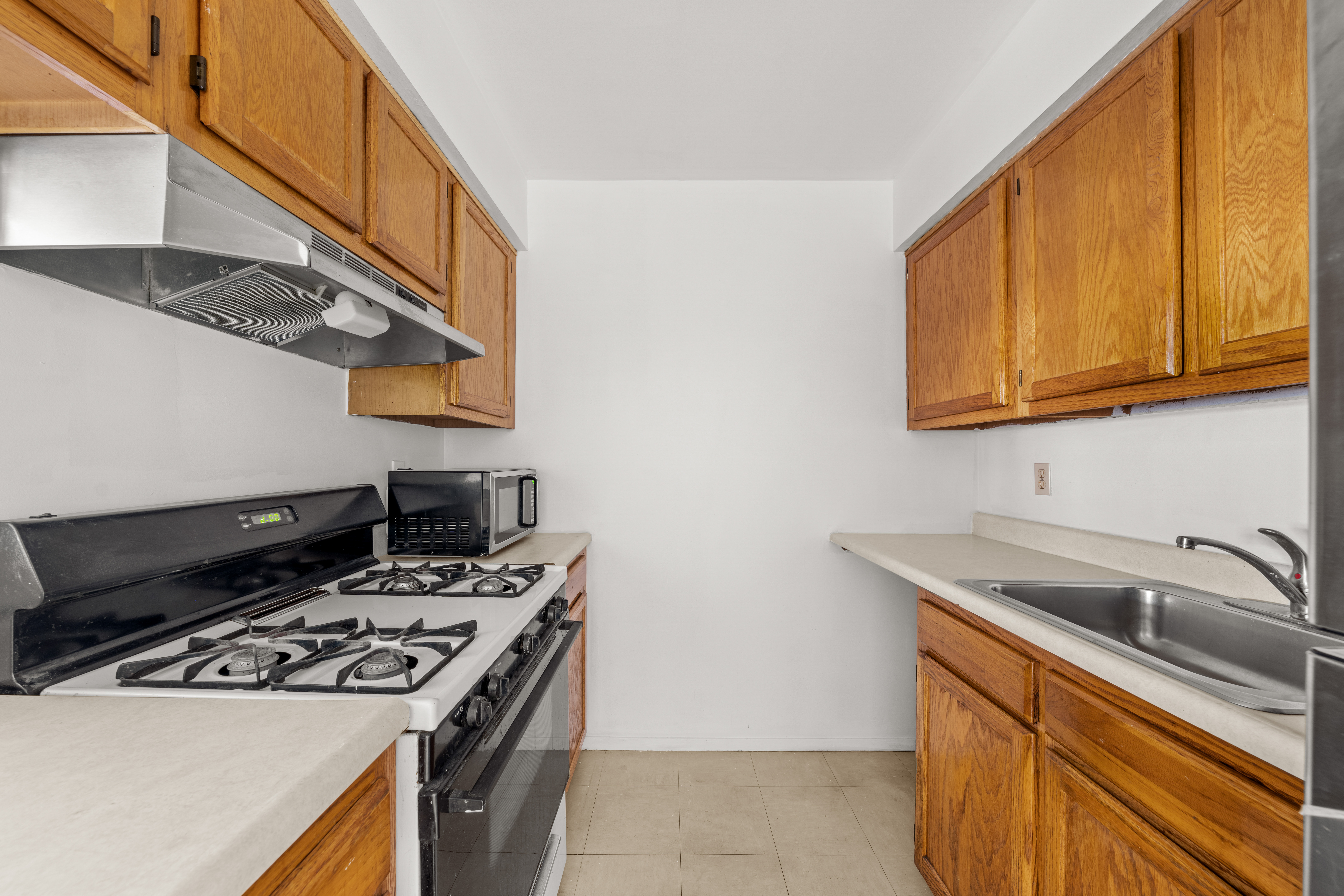 1050 Dekalb Avenue, Unit 2 Brooklyn, NY 11221 - Photo 4 of 10 a kitchen with stainless steel appliances granite countertop a sink and a stove