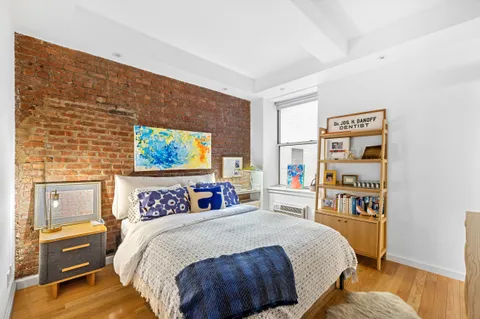 a bedroom with a bed and a desk