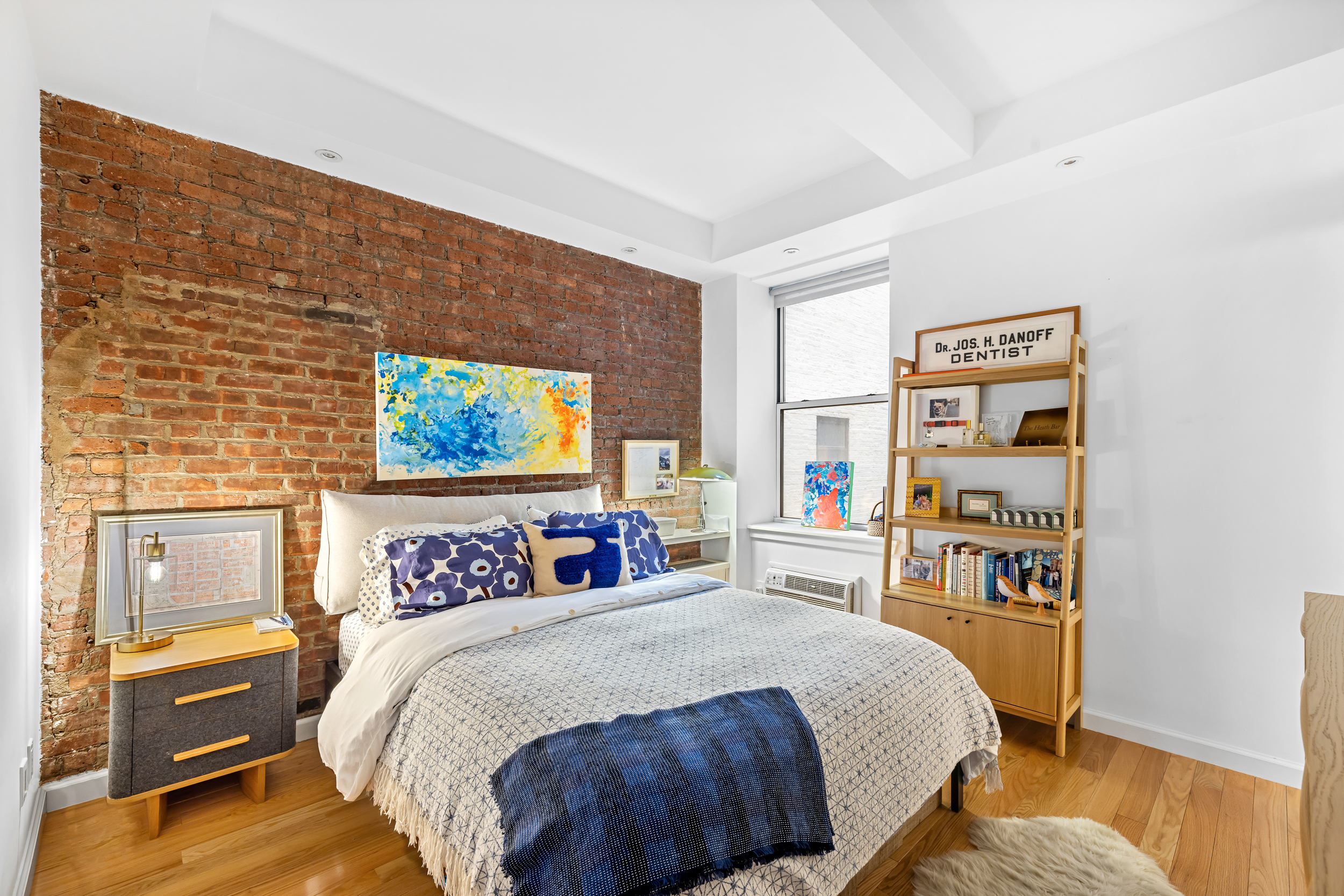 23 East 10th Street, Unit 231 Manhattan, NY 10003 - Photo 6 of 9 a bedroom with a bed and a desk