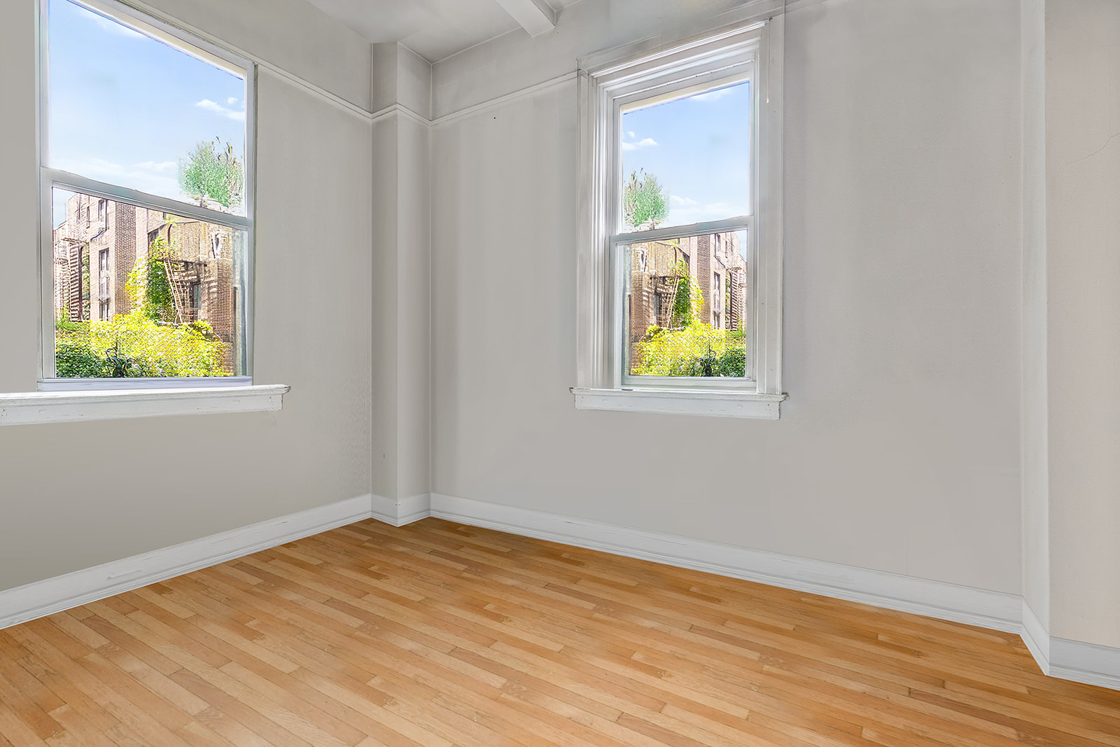 41 Eastern Parkway, Unit 1D Brooklyn, NY 11238 - Photo 11 of 16 a view of an empty room with wooden floor and a window