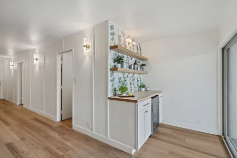 a view of kitchen with stainless steel appliances cabinets and wooden floor
