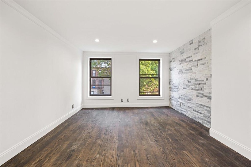 308 Clifton Place Brooklyn, NY 11216 - Photo 24 of 41 wooden floor in an empty room with a window
