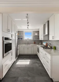a kitchen with stainless steel appliances a stove sink and cabinets